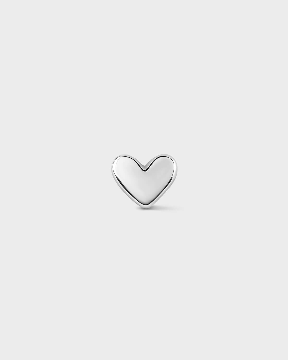 White gold heart-shaped earring on a light gray background