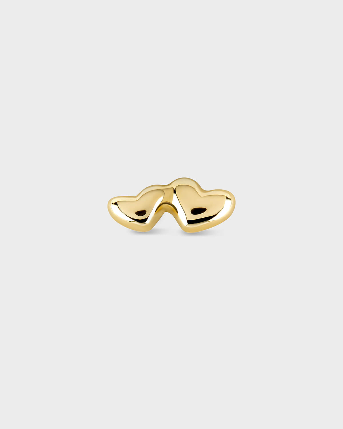 Gold heart-shaped earring on a white background