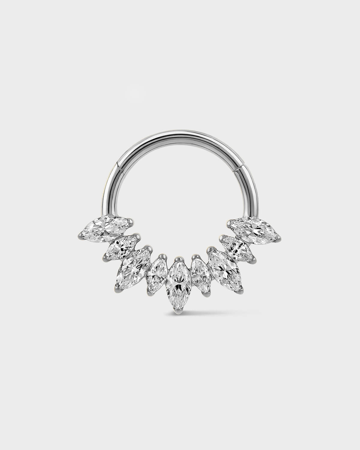 Polished silver titanium daith ring with alternating graduated marquise gemstones on a light gray background.