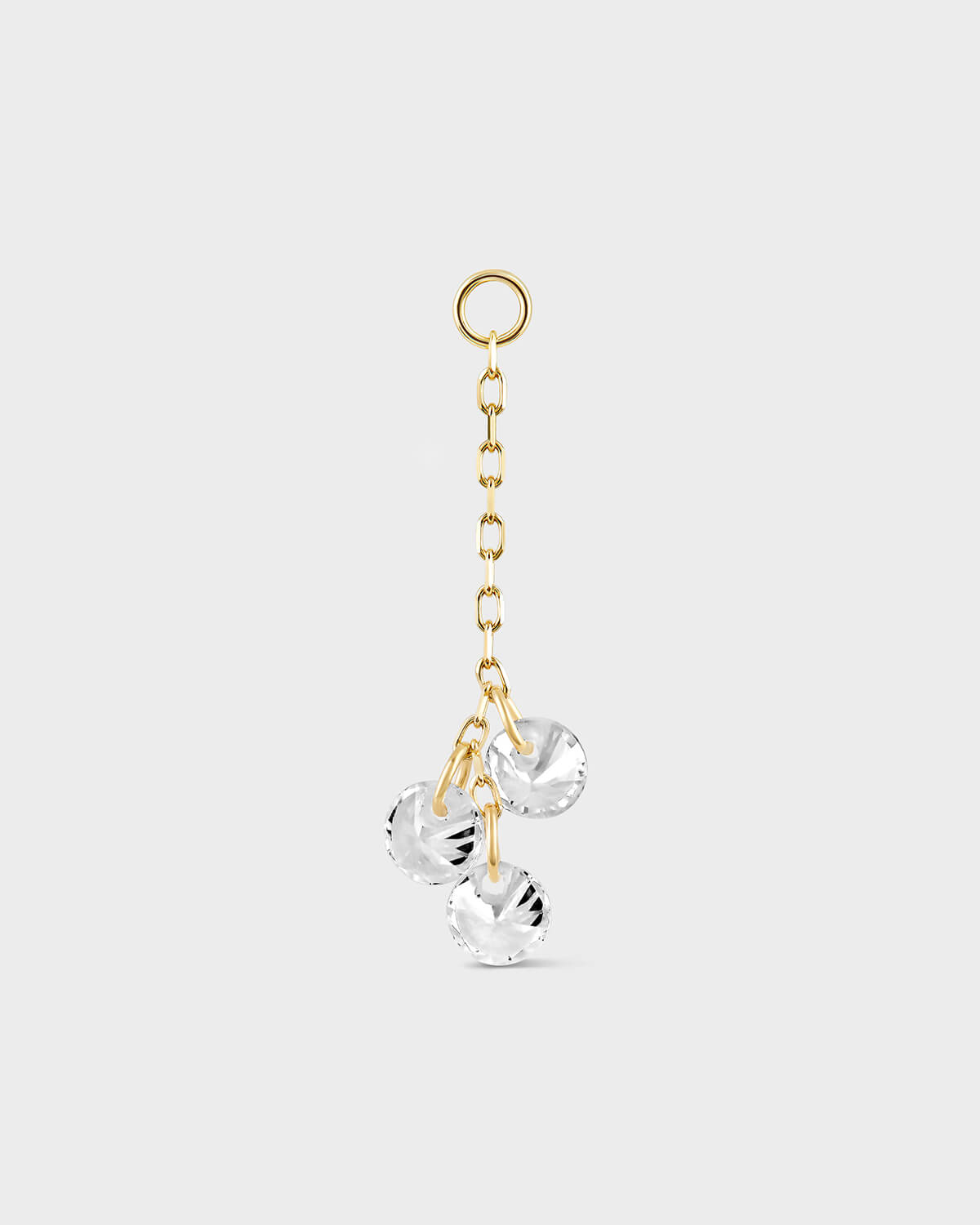 Gold earring chain with three clear crystal pendants on a white background