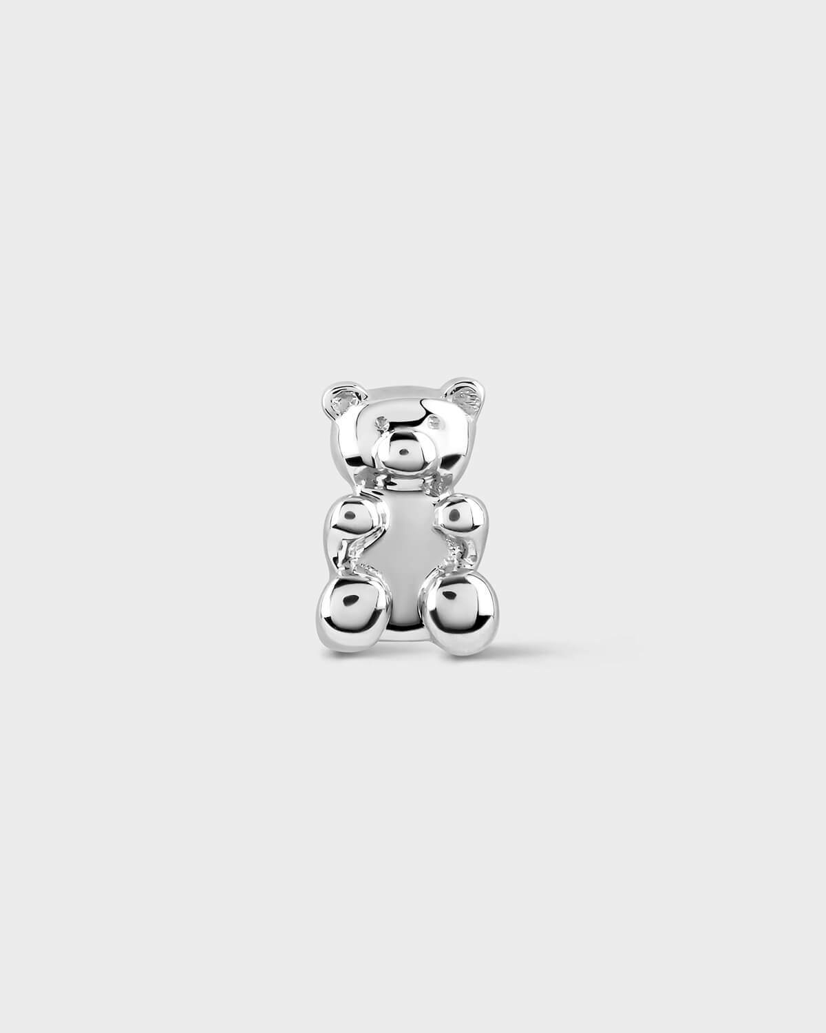White gold teddy bear earring on a light gray background