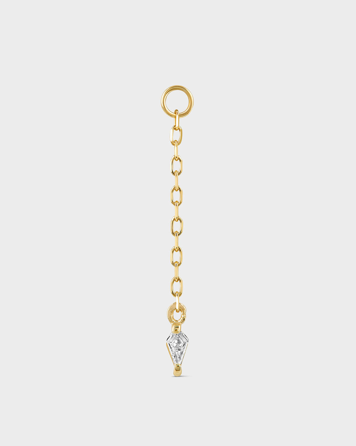Gold chain with a diamond pendant on a light gray background