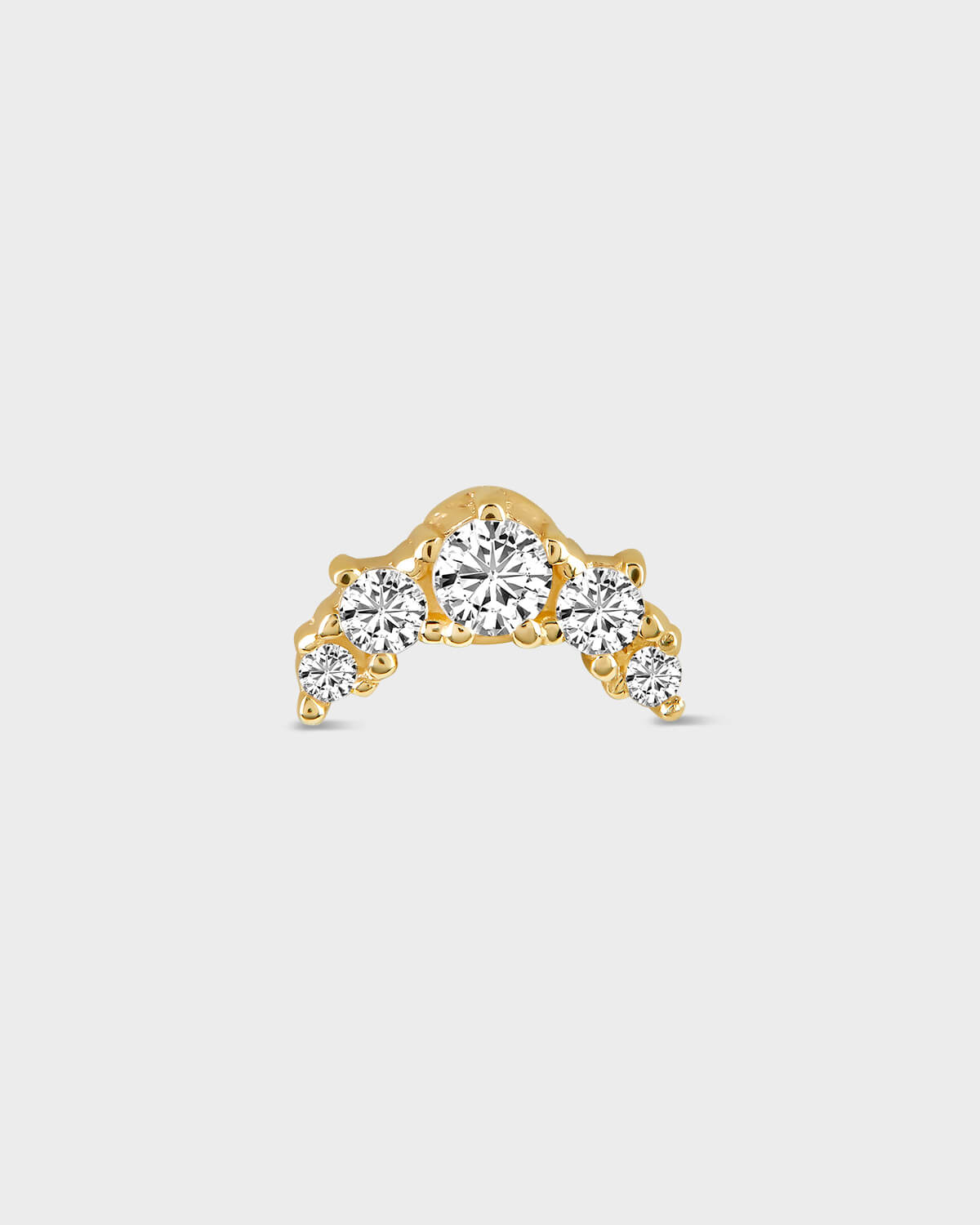 Gold earring with five diamonds on a light gray background