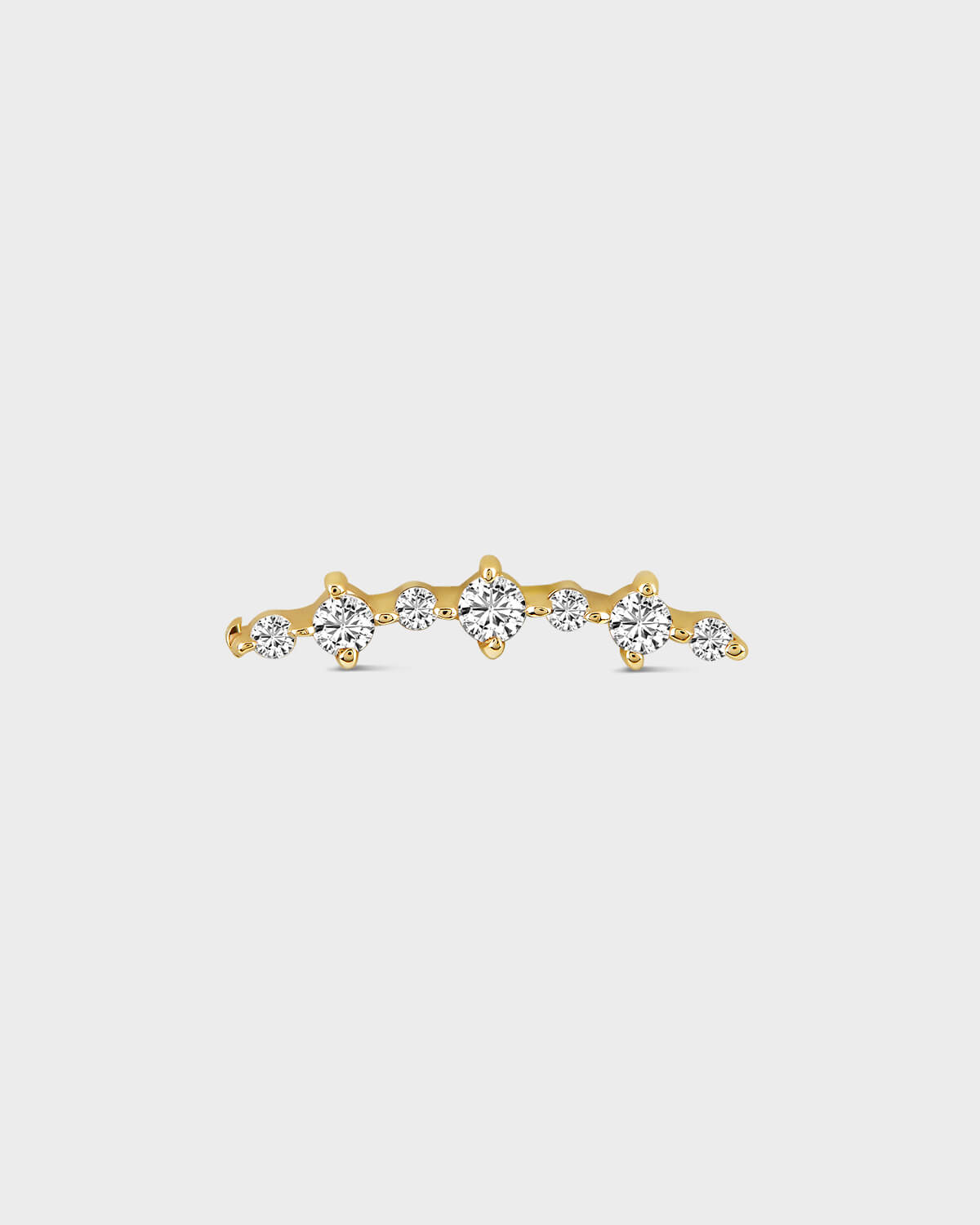 Gold earring with diamonds on a light gray background