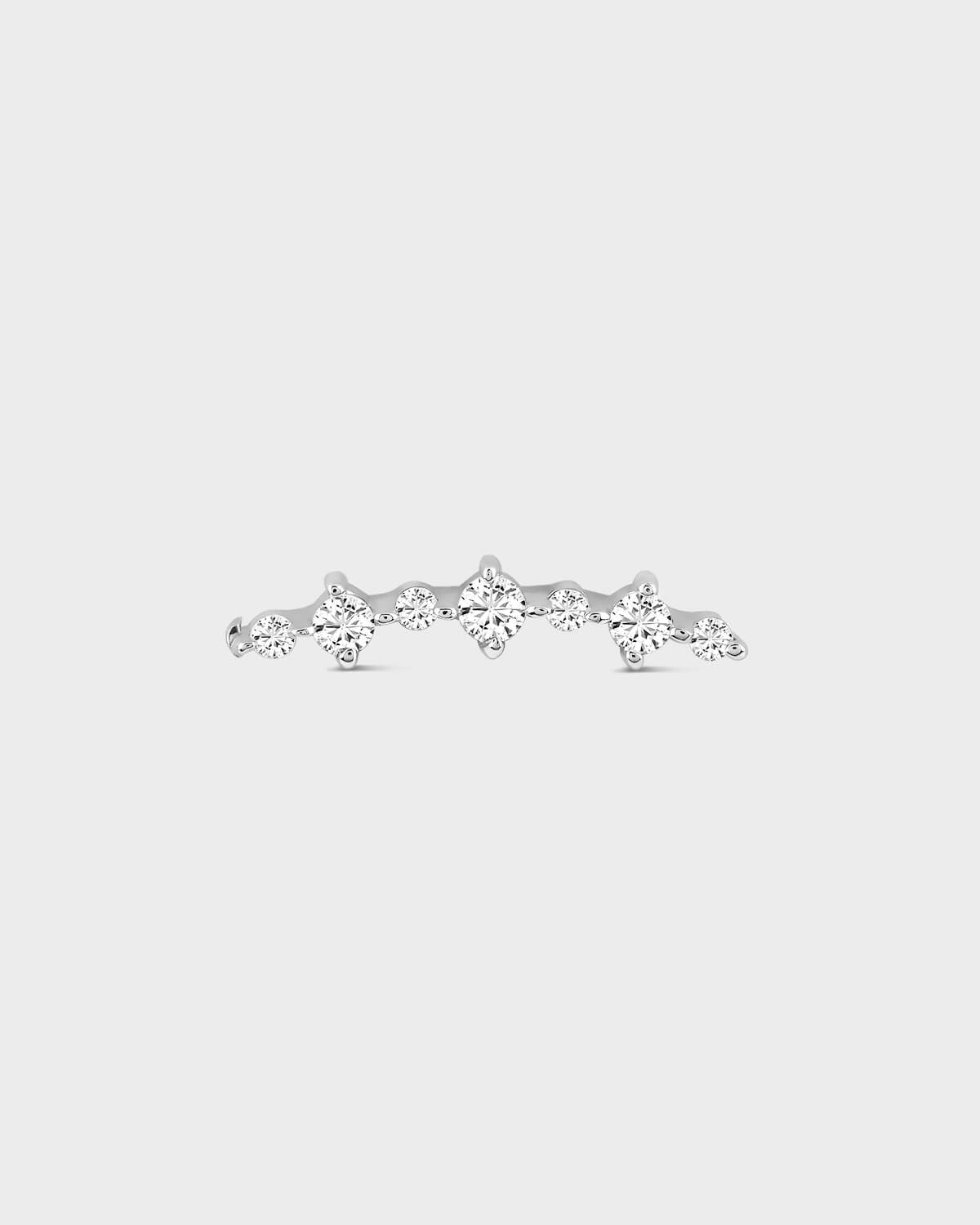 Silver earring with multiple diamonds on a light gray background