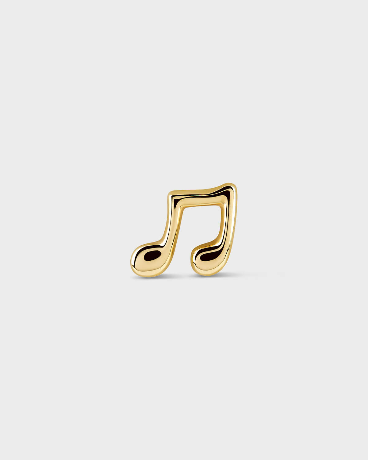 Gold music note earring on a light gray background
