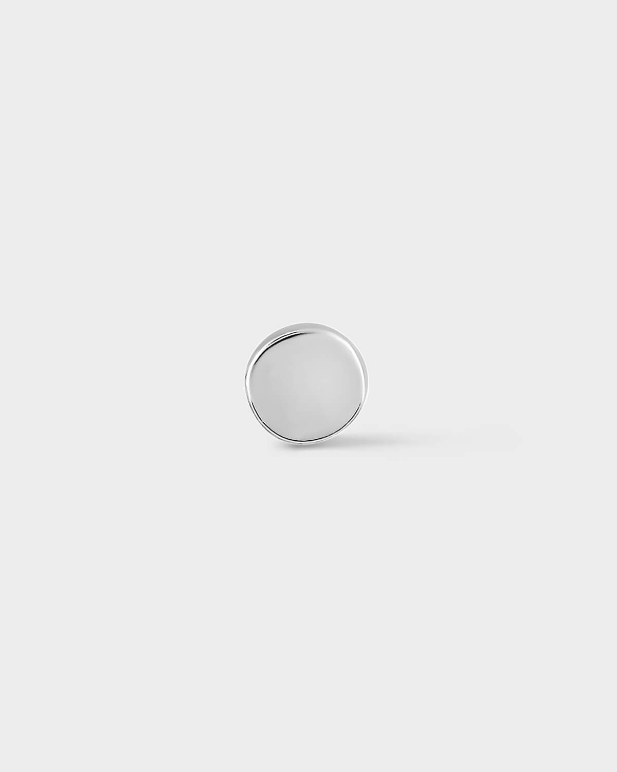 White gold round earring on a light gray background