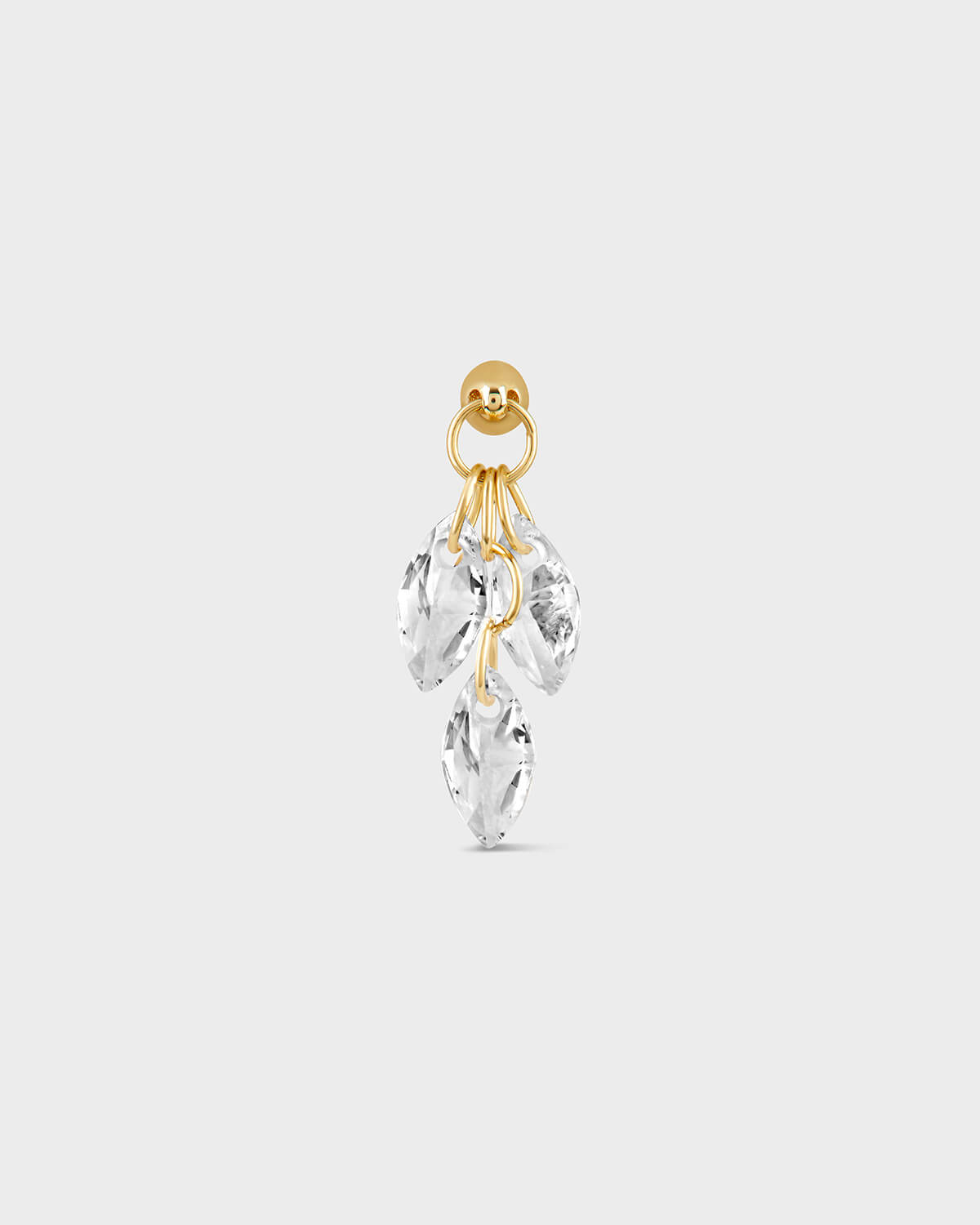 Gold earring with clear crystal stones on a white background