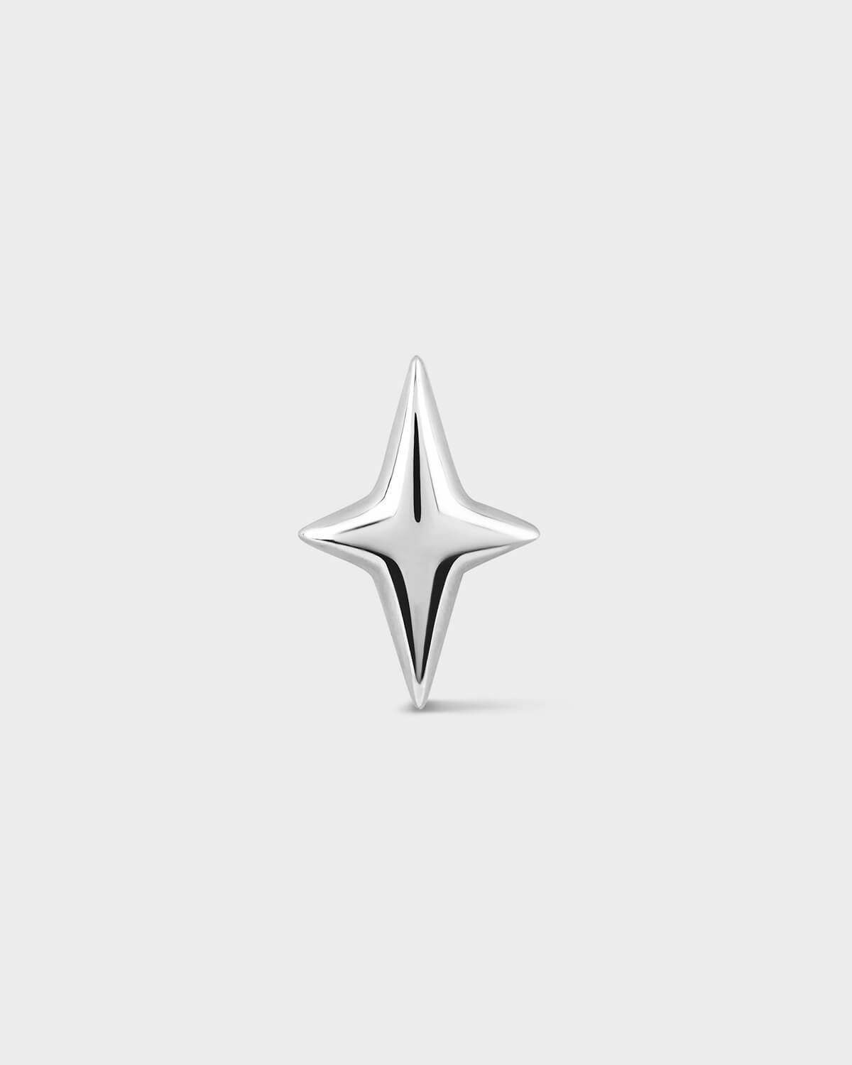 White gold star-shaped earring on a light gray background