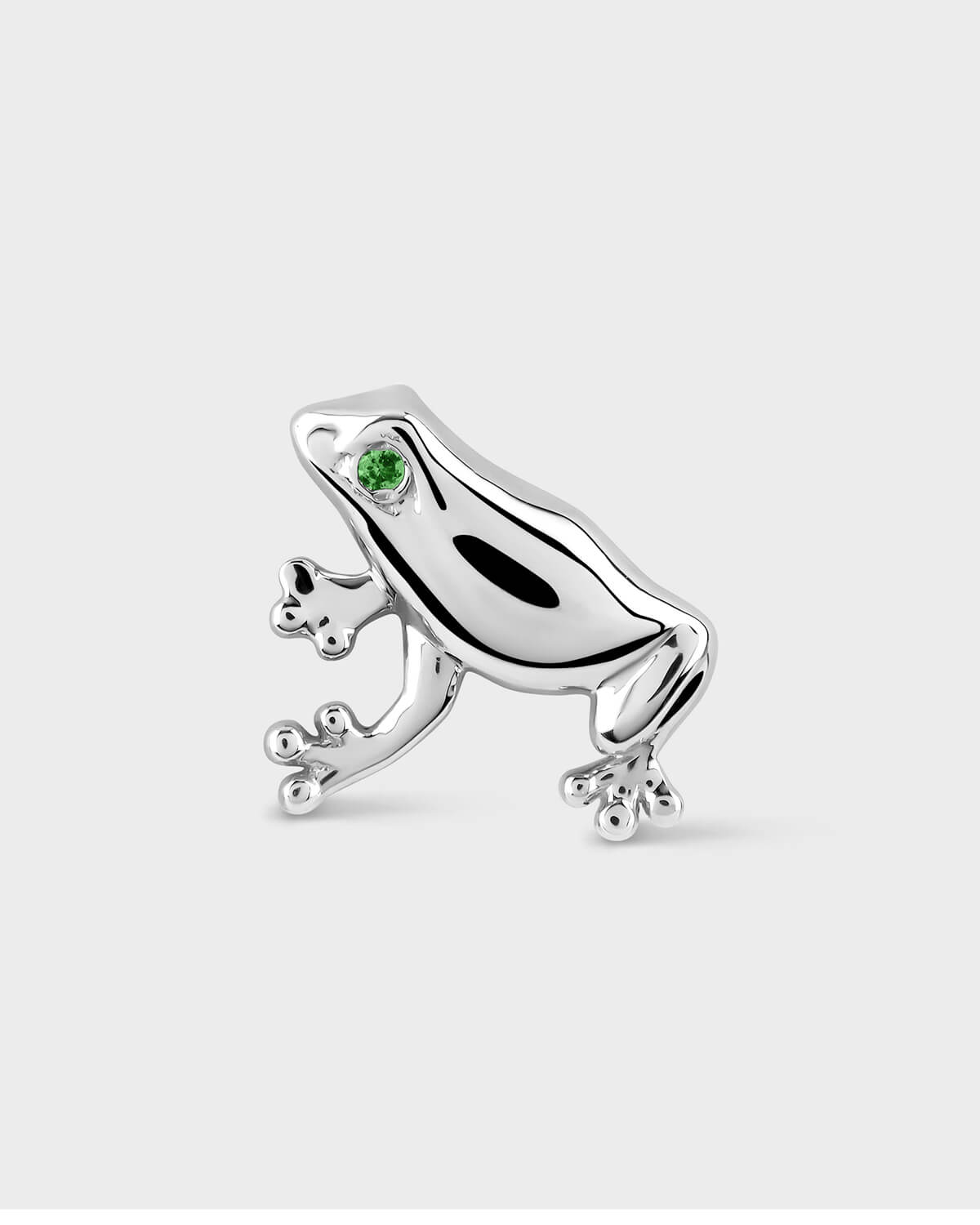 White gold frog-shaped earring with a green gemstone on a white background